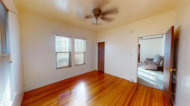 a bedroom with a bed and a ceiling fan