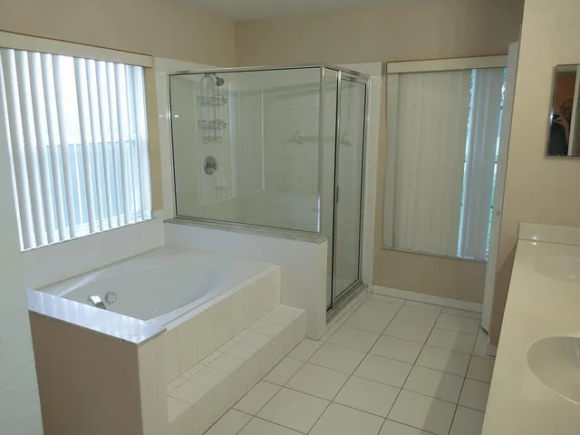 a bathroom with a bathtub and shower