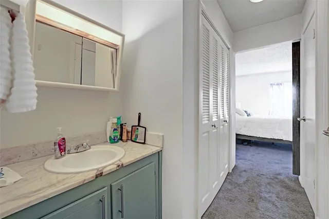 a white toilet sitting next to a bathroom sink