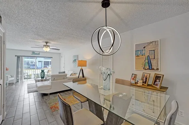 a living room with furniture a rug chandelier and a window