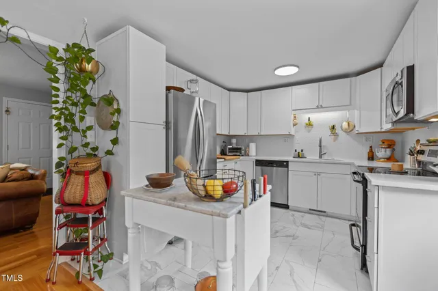 a kitchen with a refrigerator and a stove