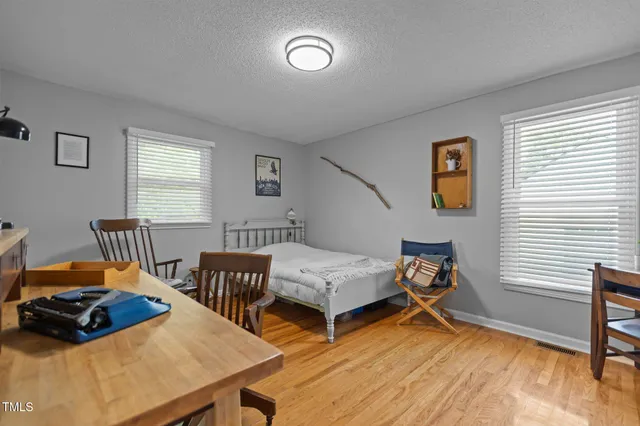 a bedroom with furniture and a wooden floor