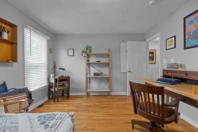 a bedroom with furniture and a window