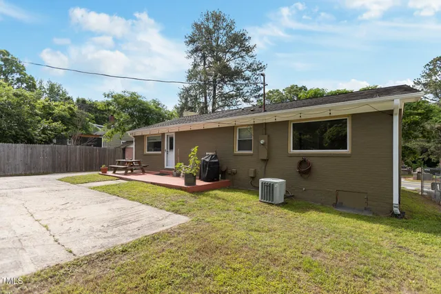 a backyard of a house with garden and barbeque oven