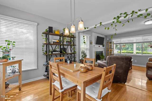 a view of a dining room with furniture a chandelier and wooden floor