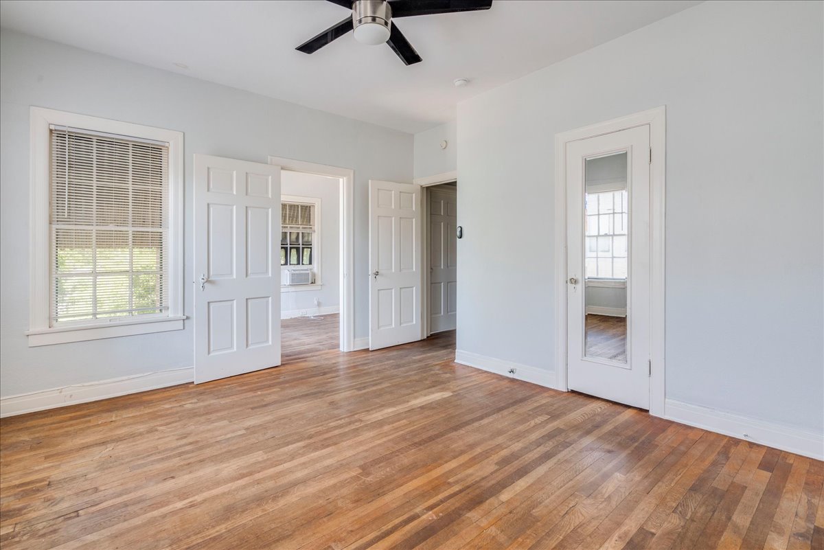 1916 Robbins Place Austin, TX 78705 - Photo 13 of 21 an empty room with wooden floor cabinet and windows