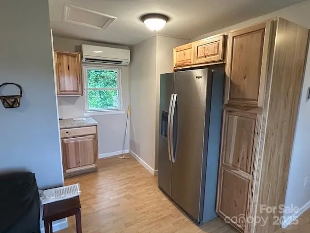 a kitchen with stainless steel appliances granite countertop a refrigerator and a stove top oven
