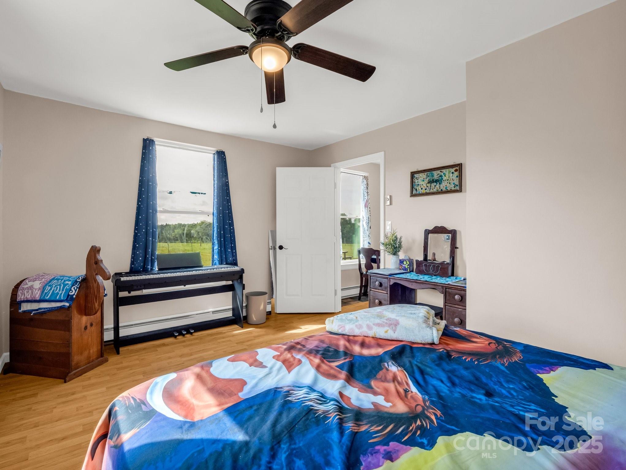 847 Crowe Dairy Road Forest City, NC 28043 - Photo 23 of 35 a bedroom with a bed and a chandelier