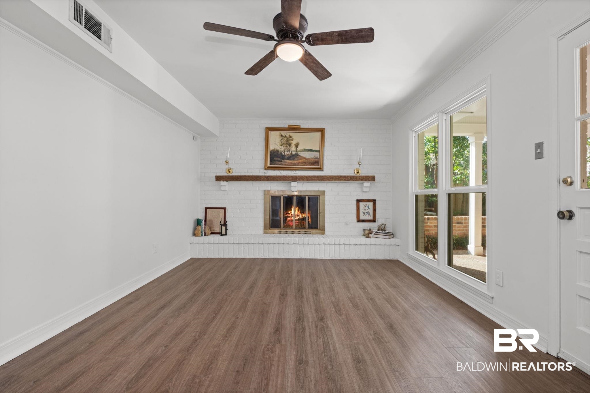 511 Wacker Lane North Mobile, AL 36608 - Photo 15 of 45 Unfurnished living room with dark wood-type flooring, a brick fireplace, and ceiling fan