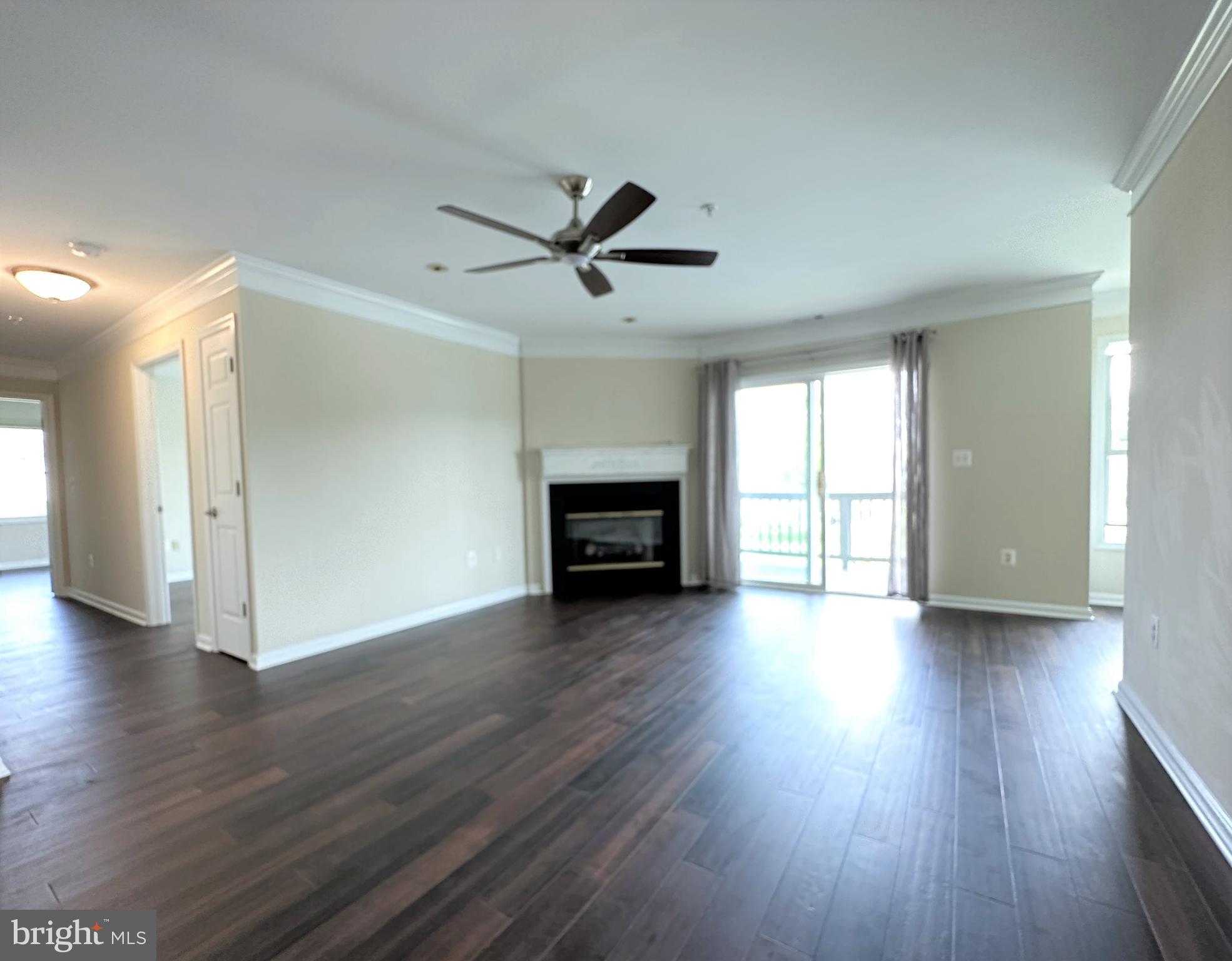 312 Teal Court, Unit F Chester, MD 21619 - Photo 9 of 25 Living room leading to deck