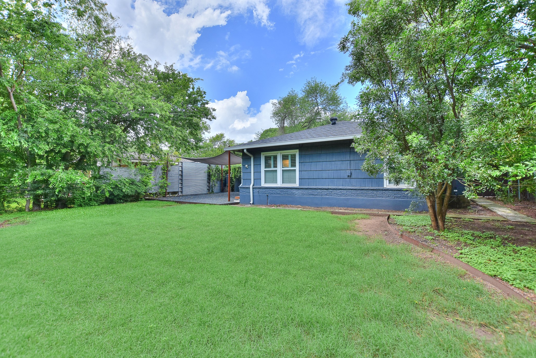 1309 Ridgemont Drive Austin, TX 78723 - Photo 32 of 35 This home offers established lush landscaping and trees but leaves plenty of room to create your own personal spaces!