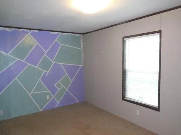 an empty room with windows and a ceiling fan