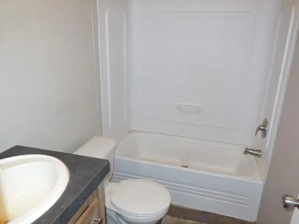 a bathroom with a toilet and a bathtub