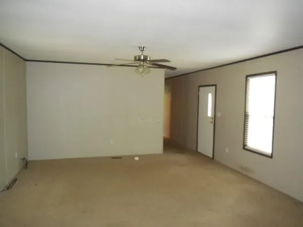 an empty room with windows and closet