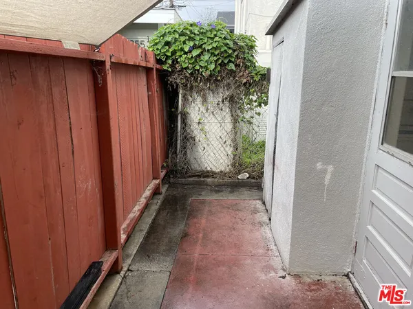 a view of a pathway with a wooden fence