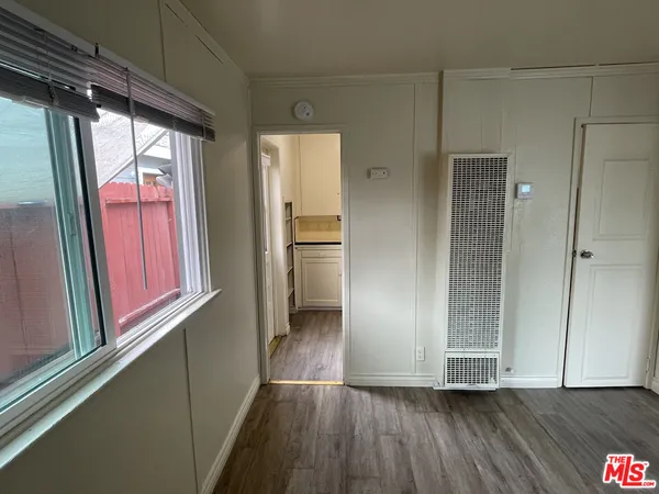 a view of hallway with wooden floor