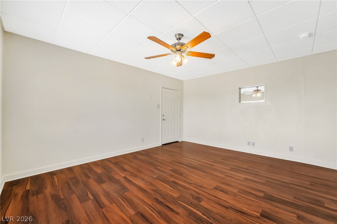 2 California Way Henderson, NV 89015 - Photo 8 of 29 Wood-look flooring anchors this versatile room, offering an adaptable space for any lifestyle.