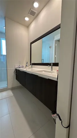 a bathroom with a sink toilet and a mirror