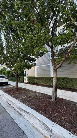a front view of a house with a yard and tree s