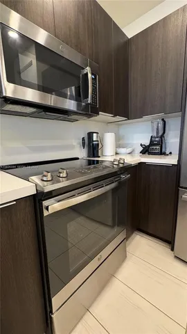 a kitchen with stainless steel appliances a sink stove and cabinets