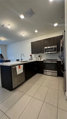 a kitchen with stainless steel appliances granite countertop a sink and cabinets