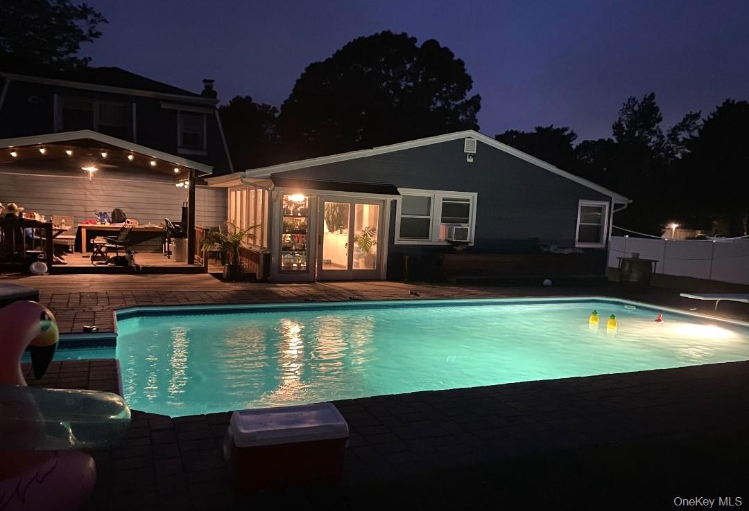 33 Lillian Road Nesconset, NY 11767 - Photo 36 of 42 Nighttime View Of The Saltwater In Ground Pool & Lighted Covered Deck.