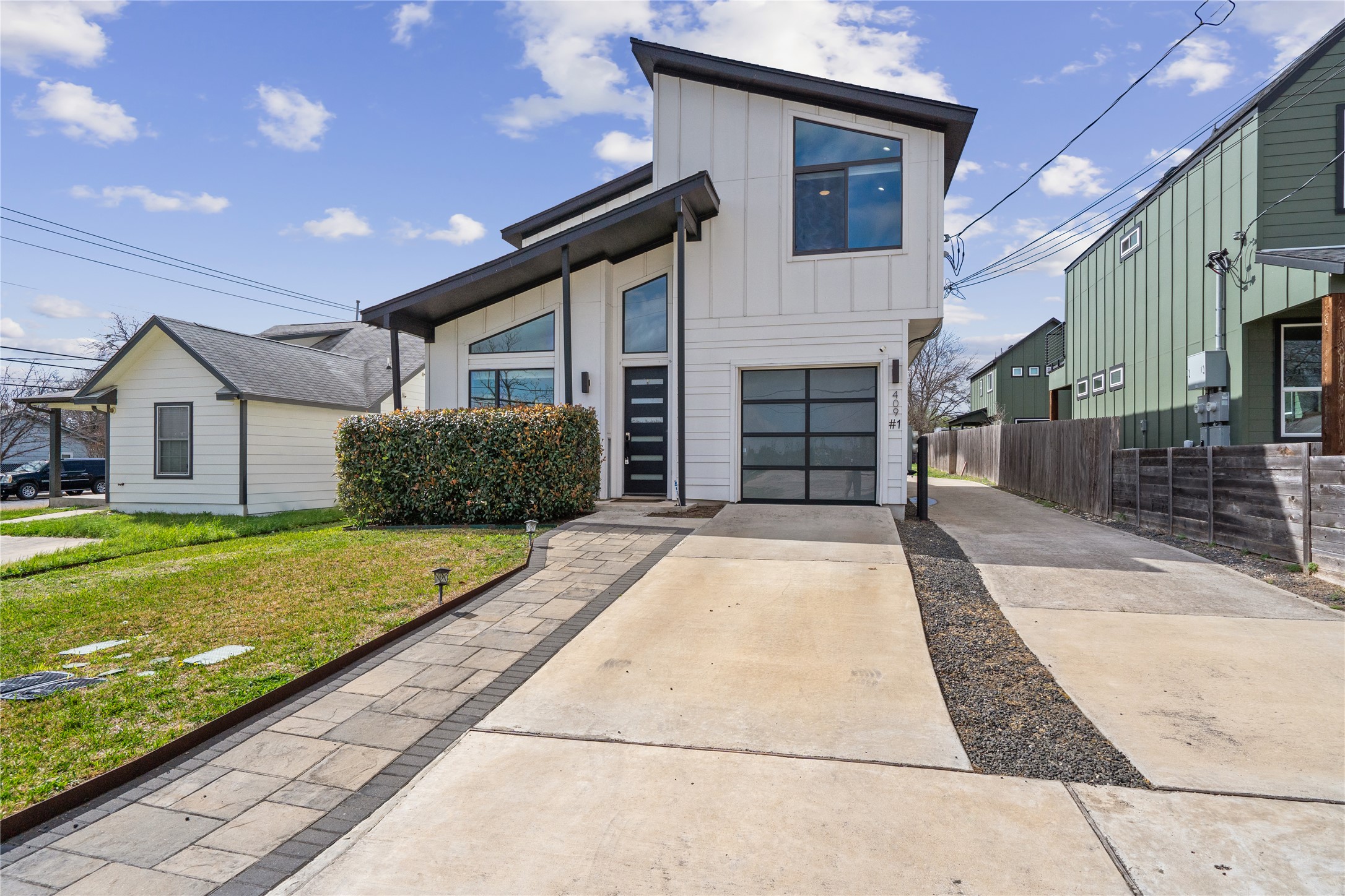 409 Delmar Avenue, Unit 1 Austin, TX 78752 - Photo 2 of 33 a house with garden in front of it
