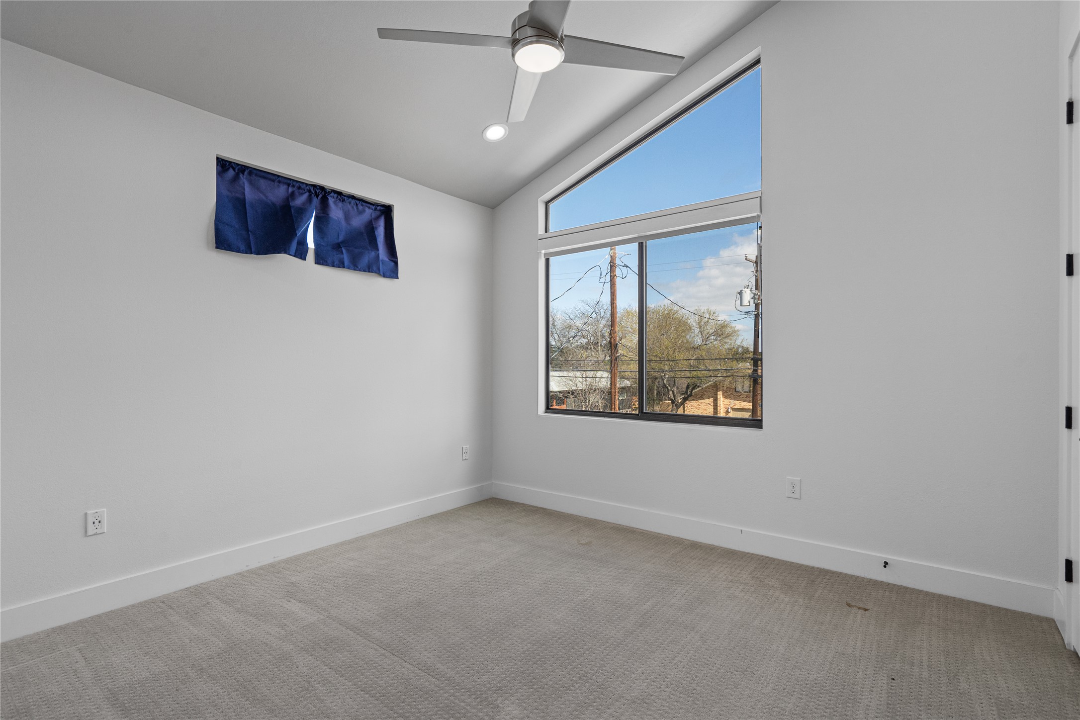 409 Delmar Avenue, Unit 1 Austin, TX 78752 - Photo 24 of 33 an empty room with windows and ceiling fan