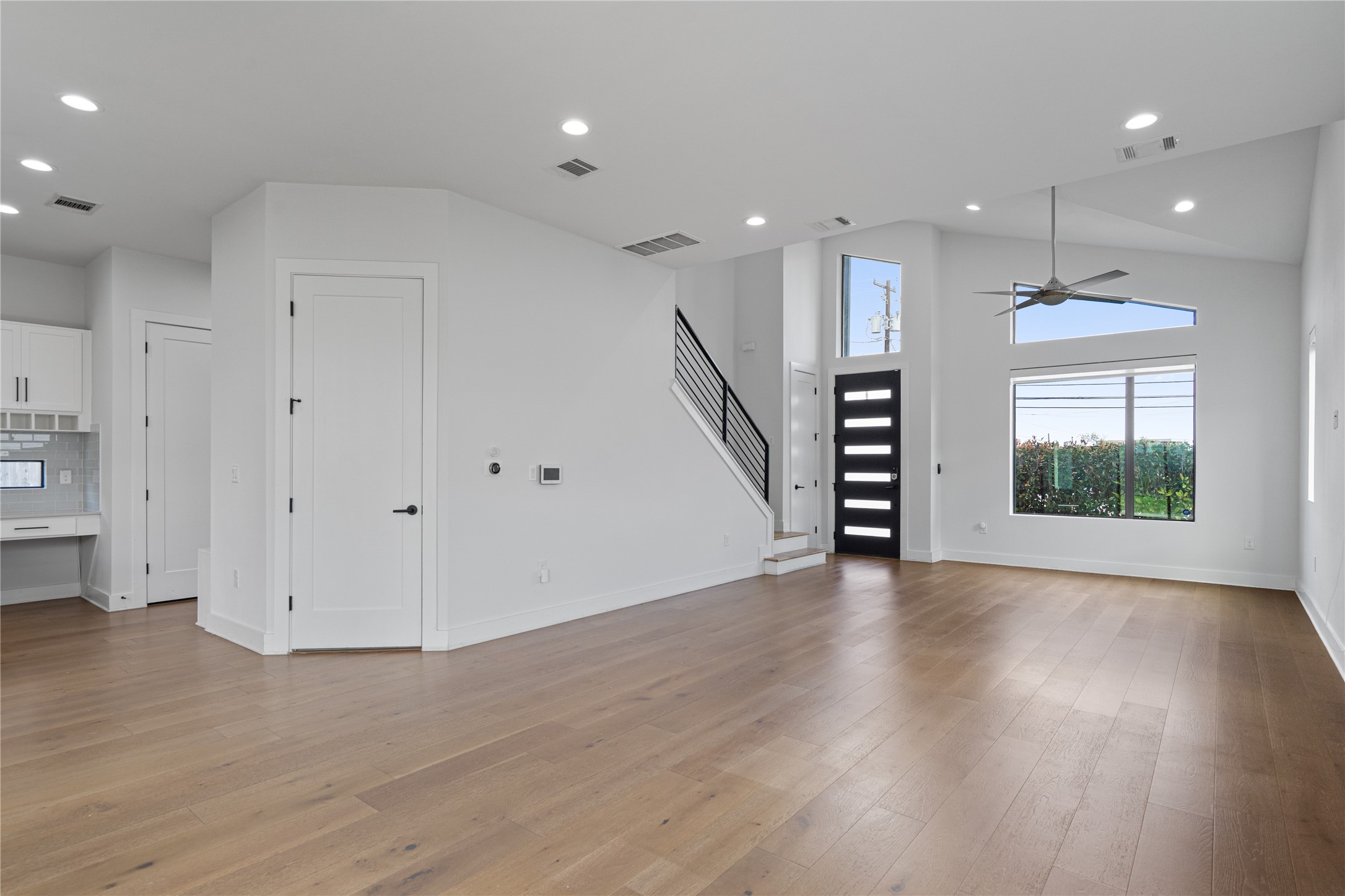 409 Delmar Avenue, Unit 1 Austin, TX 78752 - Photo 4 of 33 a view of an empty room with wooden floor kitchen and a window