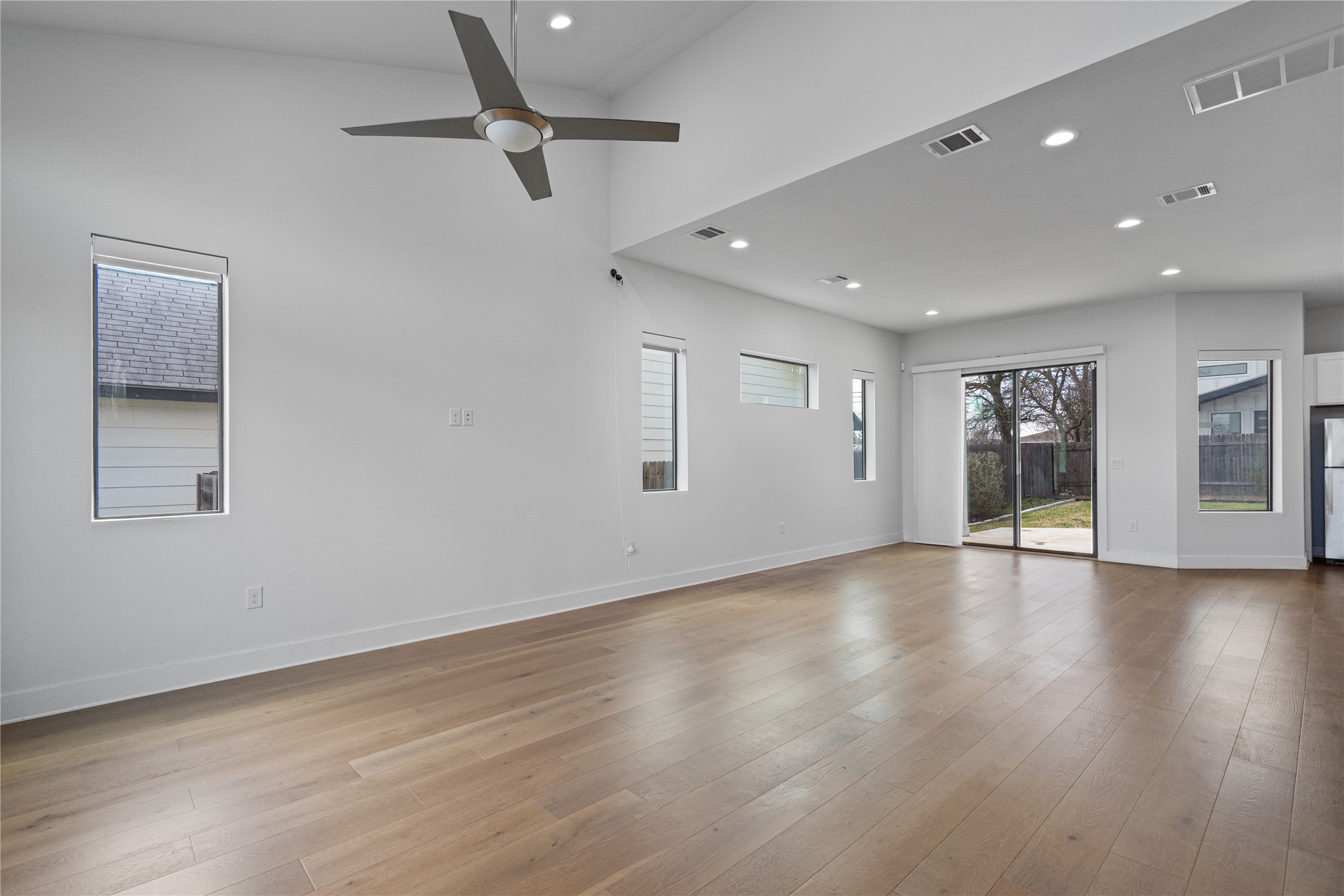 409 Delmar Avenue, Unit 1 Austin, TX 78752 - Photo 5 of 33 a view of an empty room with window and wooden floor