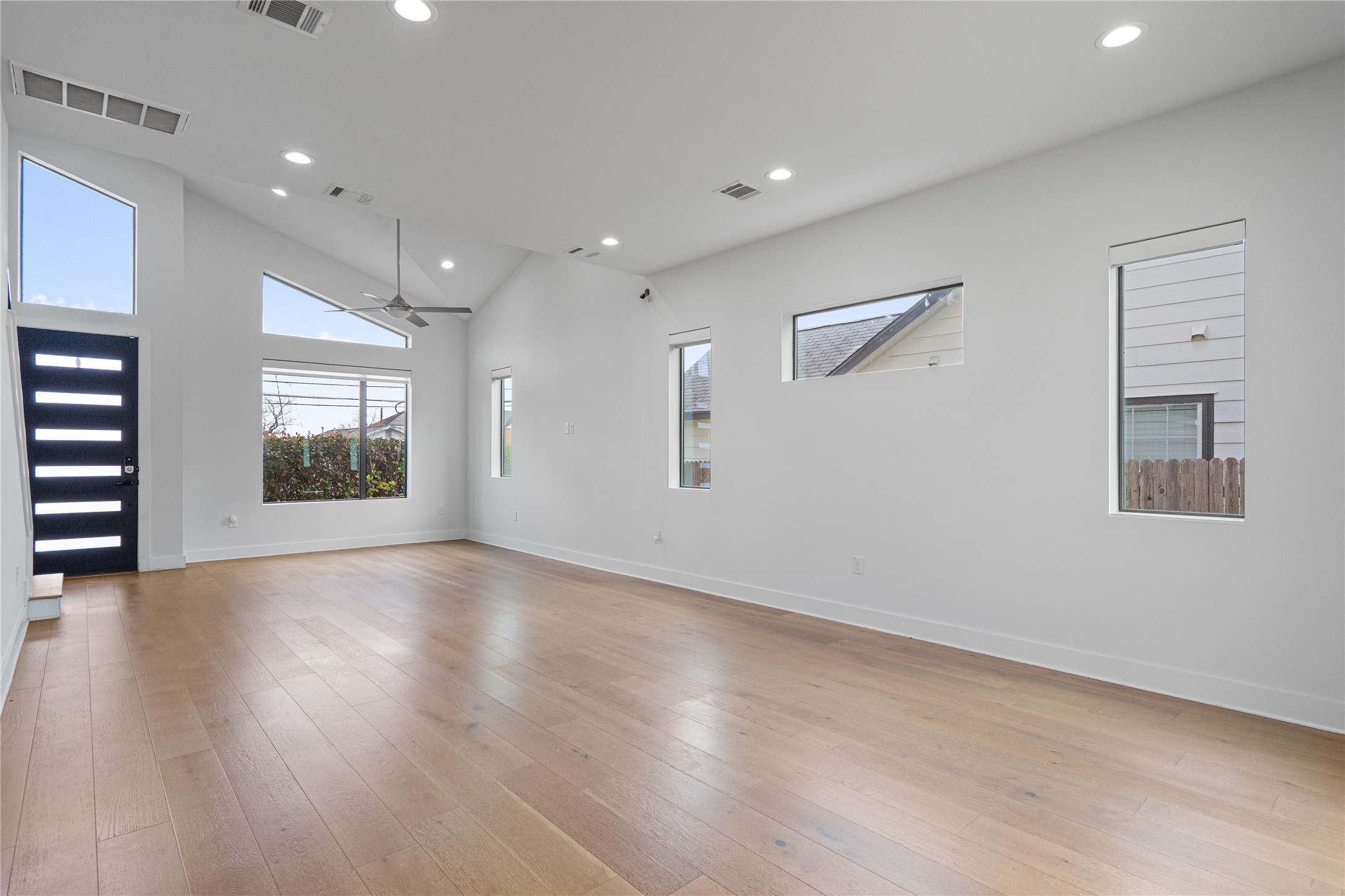 409 Delmar Avenue, Unit 1 Austin, TX 78752 - Photo 6 of 33 an empty room with wooden floor and windows