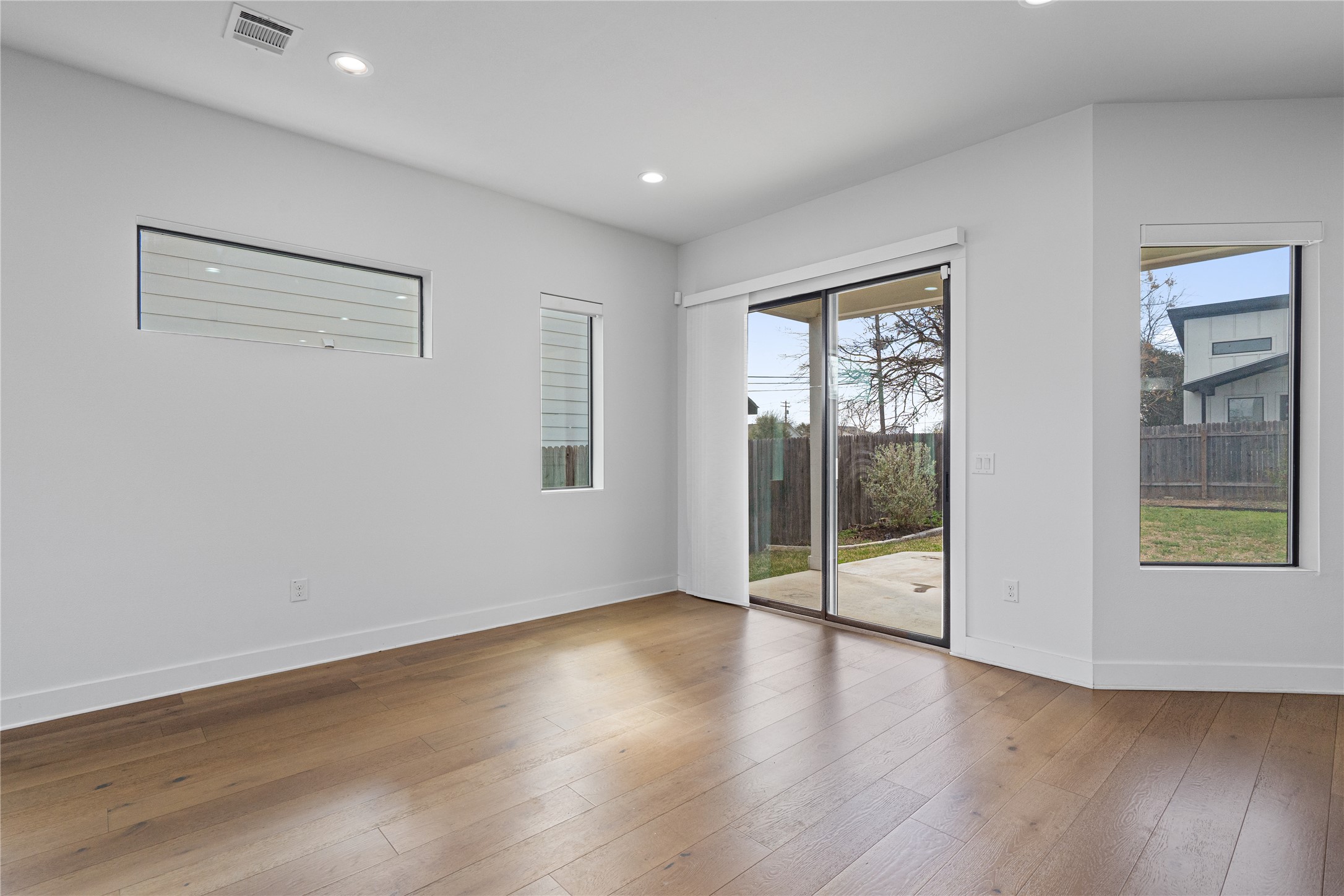 409 Delmar Avenue, Unit 1 Austin, TX 78752 - Photo 7 of 33 a view of an empty room with wooden floor and a window