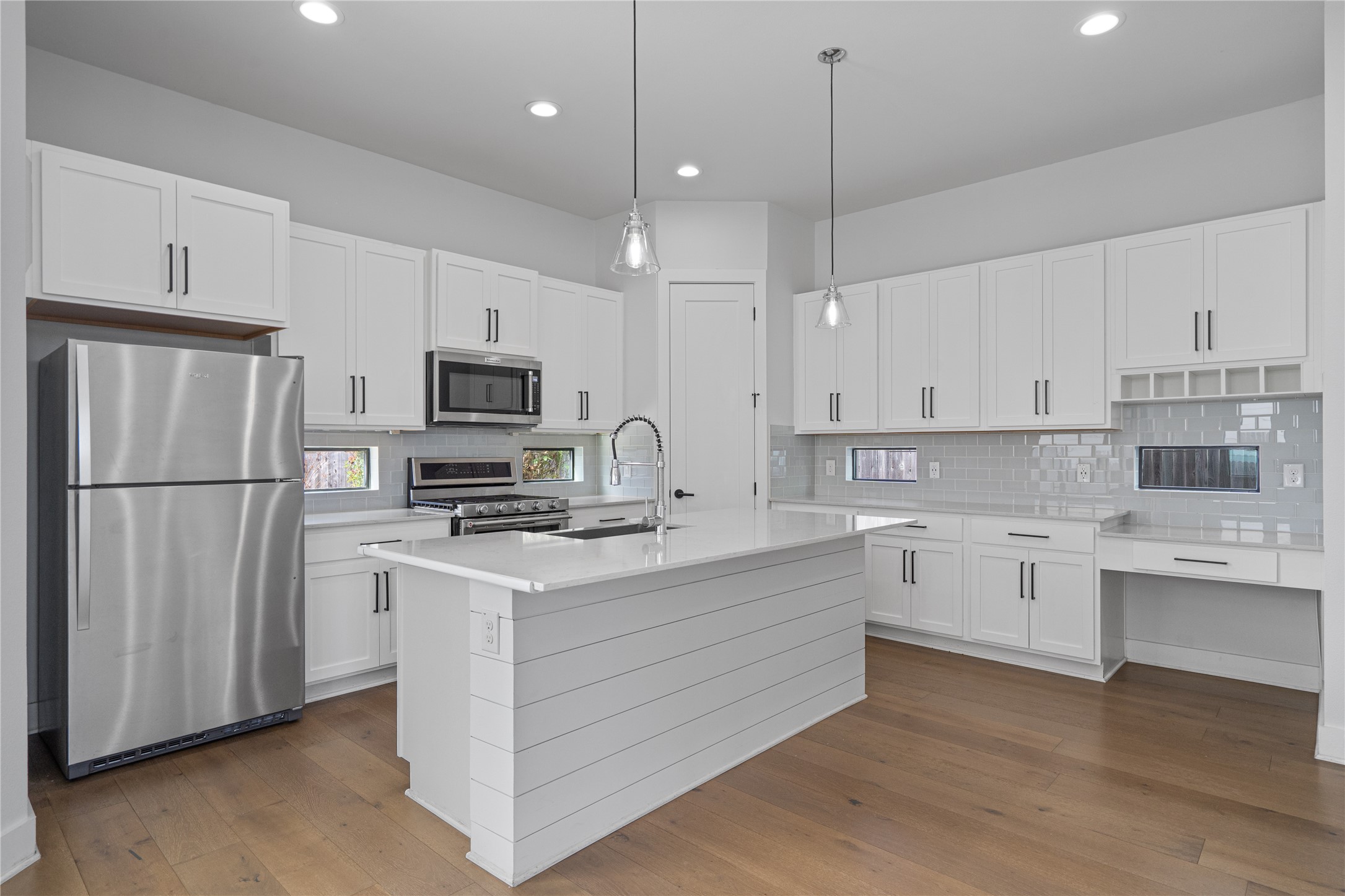 409 Delmar Avenue, Unit 1 Austin, TX 78752 - Photo 8 of 33 a kitchen with white cabinets and stainless steel appliances