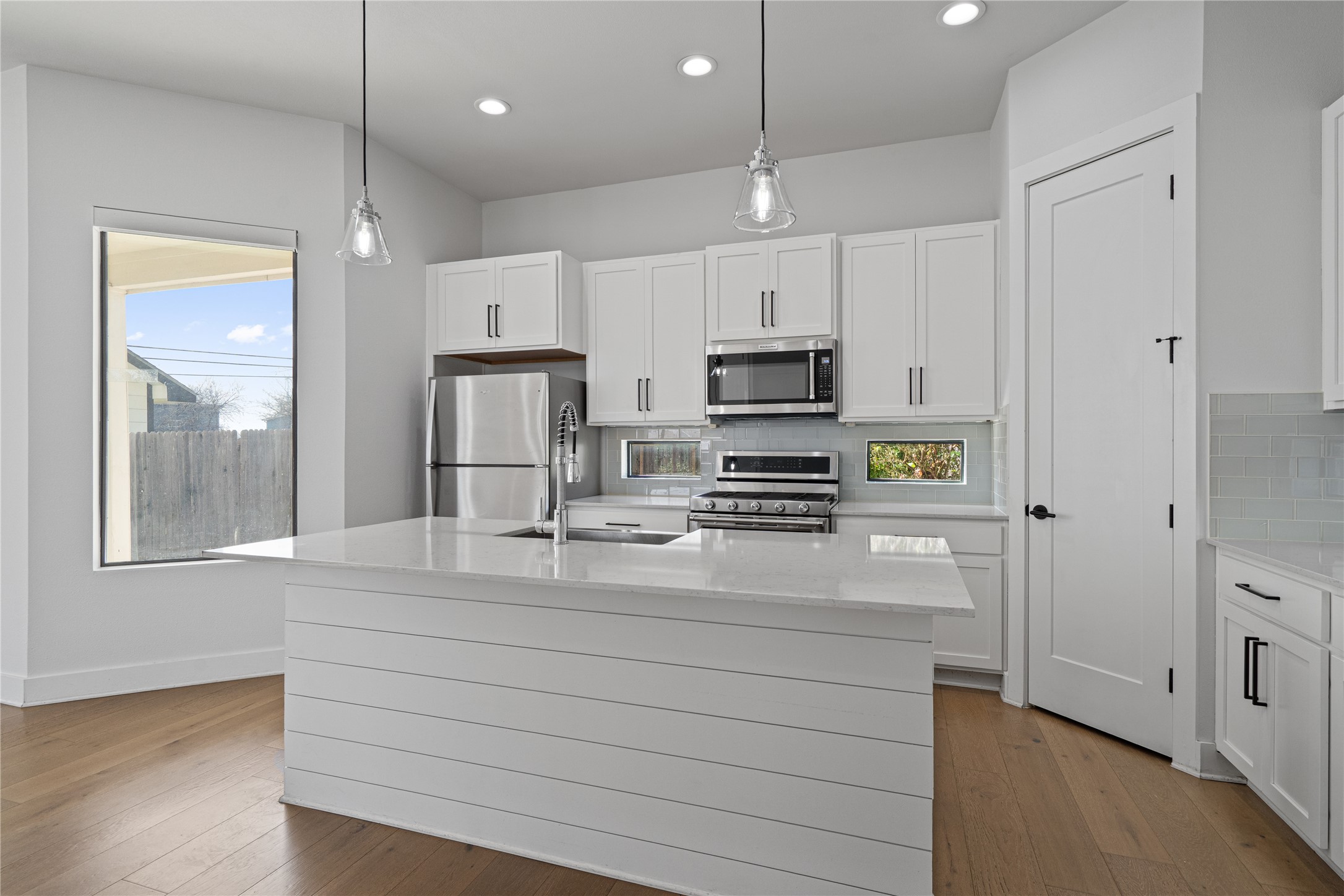 409 Delmar Avenue, Unit 1 Austin, TX 78752 - Photo 9 of 33 a kitchen with kitchen island a counter space stainless steel appliances and cabinets