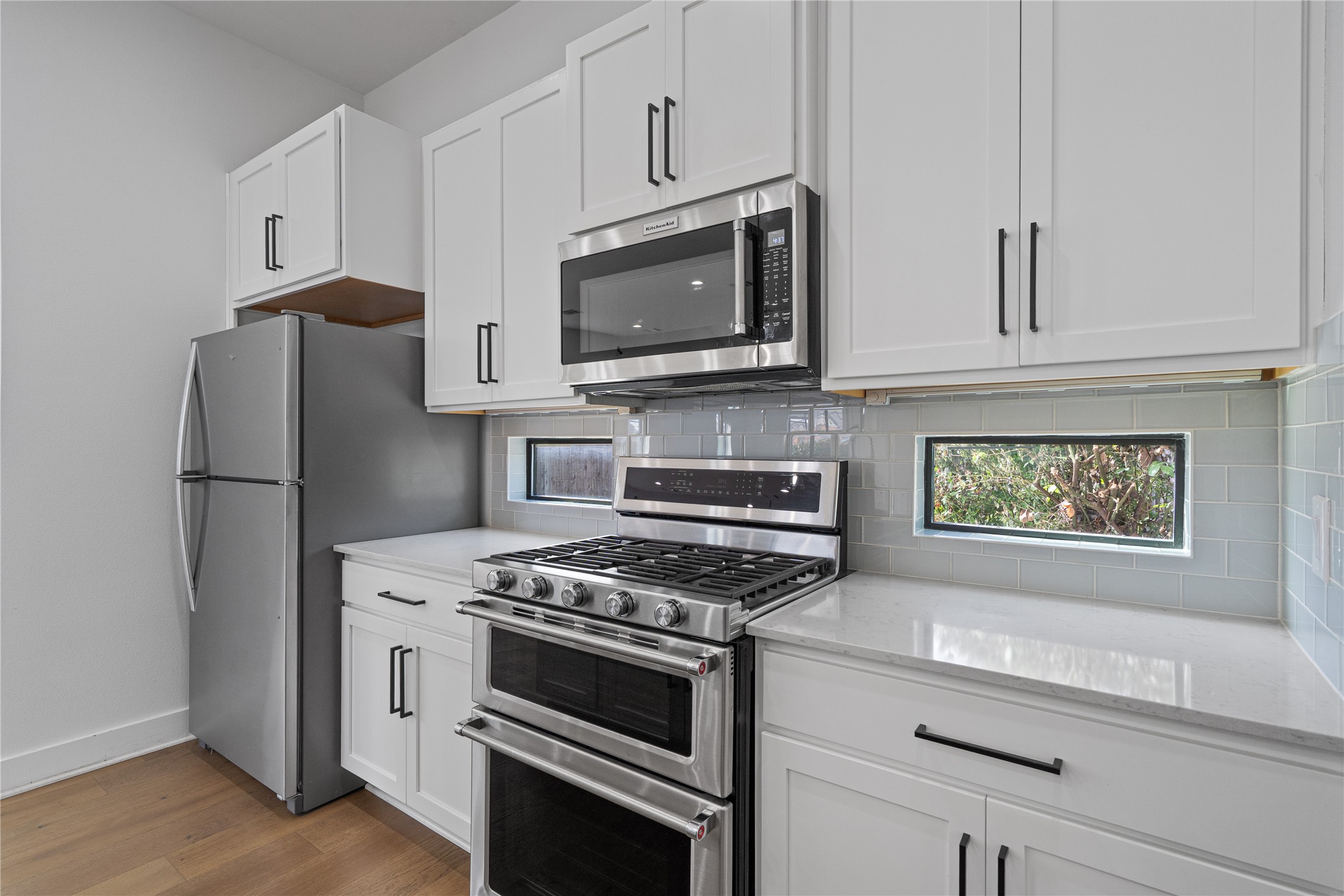 409 Delmar Avenue, Unit 1 Austin, TX 78752 - Photo 10 of 33 a kitchen with appliances a refrigerator and cabinets