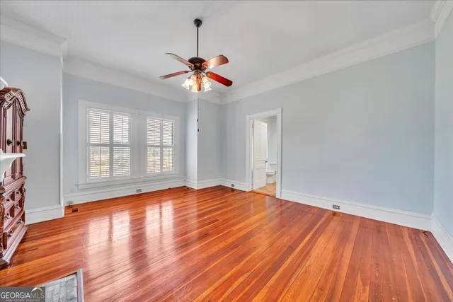 a view of an empty room with a fireplace and a window