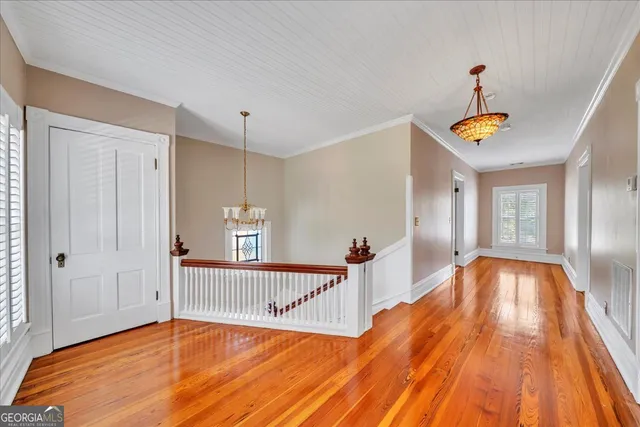 a view of a porch with wooden floor and outdoor seating