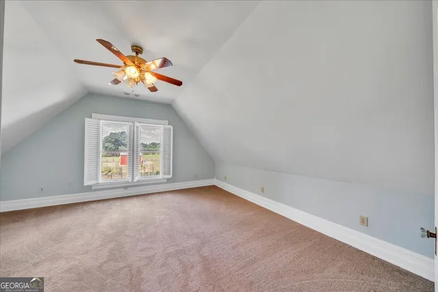 a view of a chair and table in backyard of the house