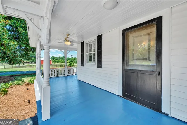 a view of a house with pool and a yard