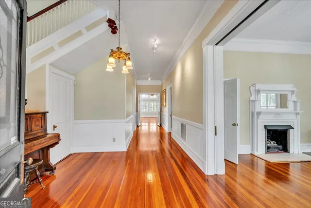 a view of a hallway view with wooden floor and staircase