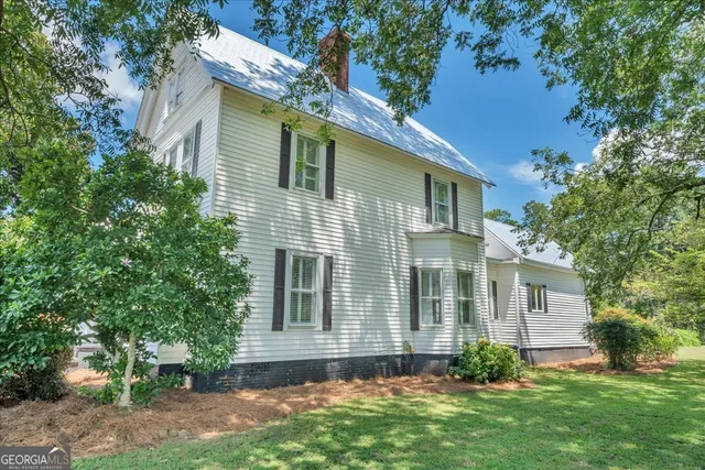 an aerial view of a residential houses with outdoor space