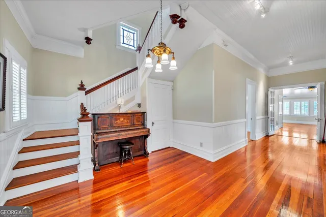 a view of entryway and hall with wooden floor