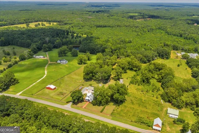 an aerial view of a house with big yard