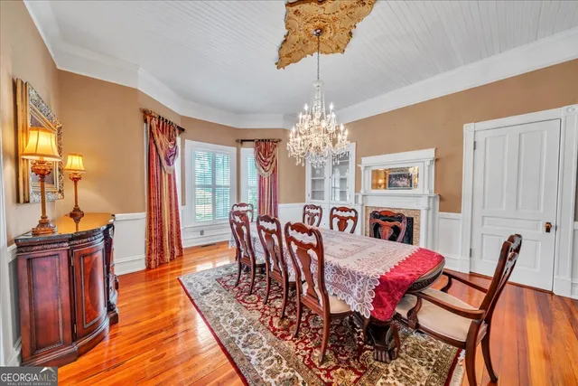 a living room with fireplace furniture and a wooden floor