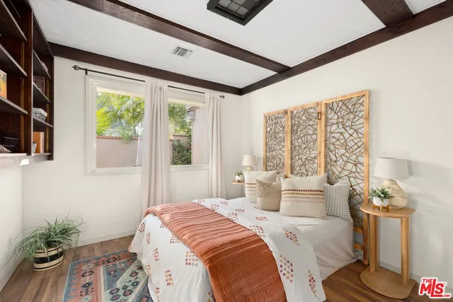 a bedroom with a bed and a potted plant