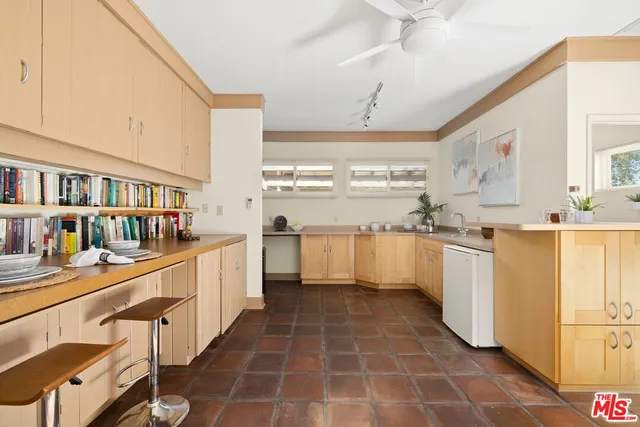 a kitchen with stainless steel appliances a stove a sink and cabinets