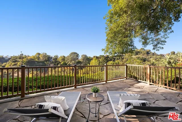 a view of a patio with a table chairs