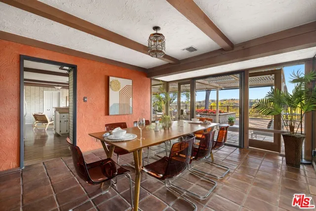 a dining room with furniture a chandelier and wooden floor