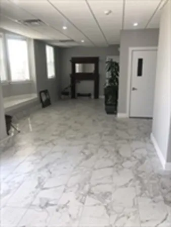 an empty room with windows and closet