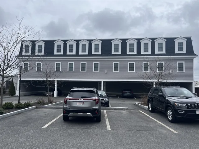a car parked in front of a big house
